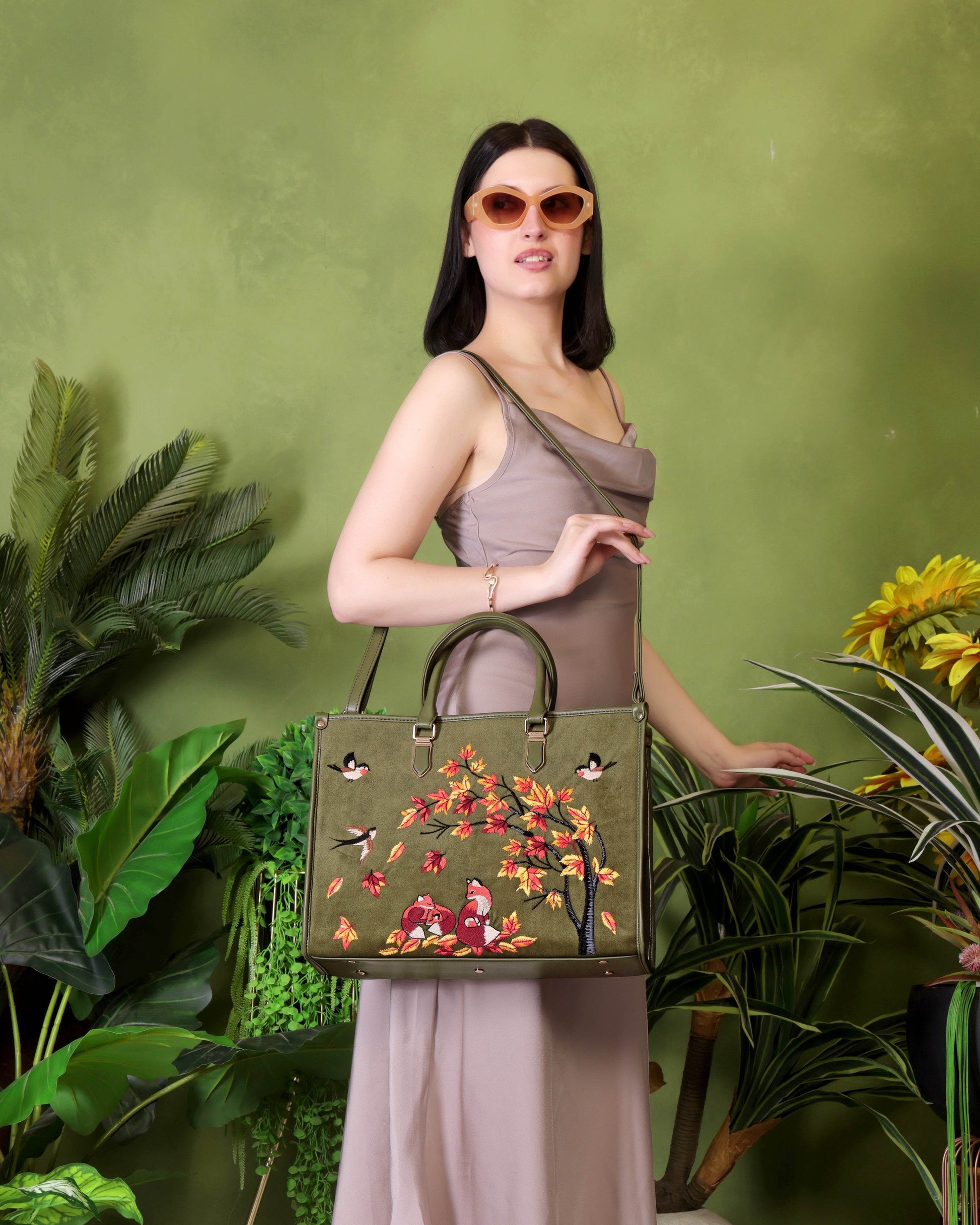Olive green travel tote bag for women in cruelty free vegan leather by PickAleaf with embroidered design for travel and weekend use